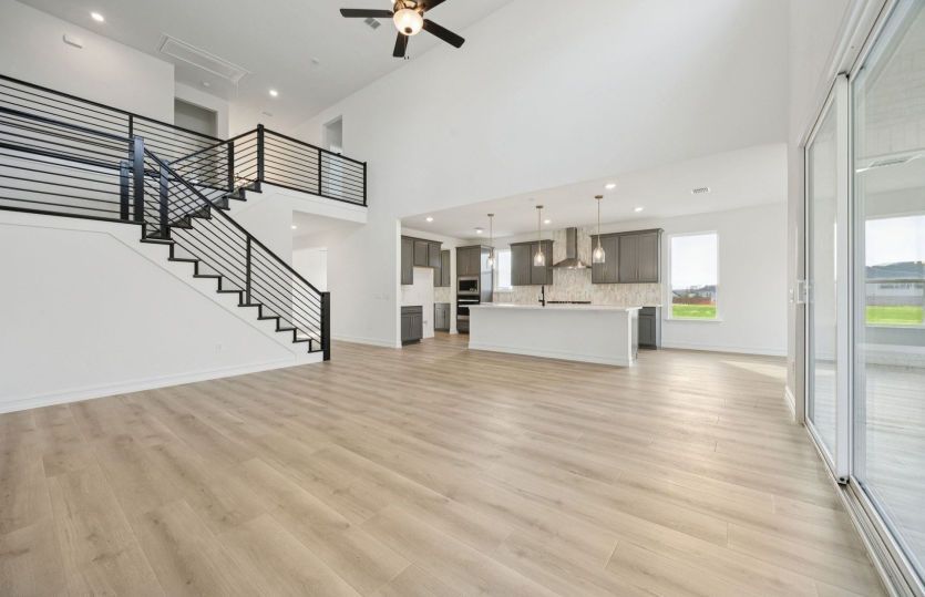 Spacious living area with view of kitchen *photos may depict options and features that aren't availa