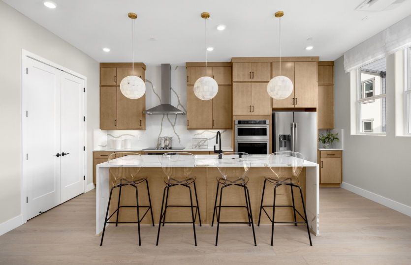 Kitchen with large central island and a waterfall edge countertop
