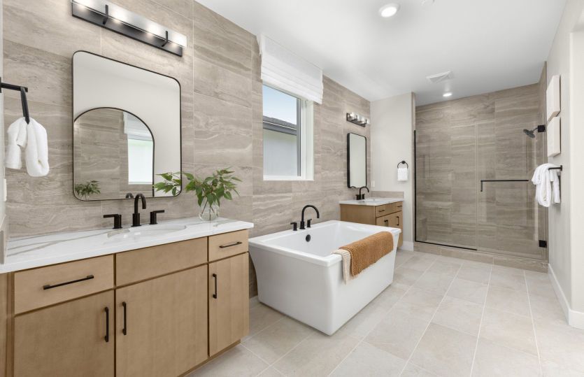 Owner's suite bathroom with a freestanding tub and glass walk in shower
