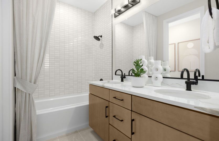 Bathroom 2 with dual vanity and tub shower