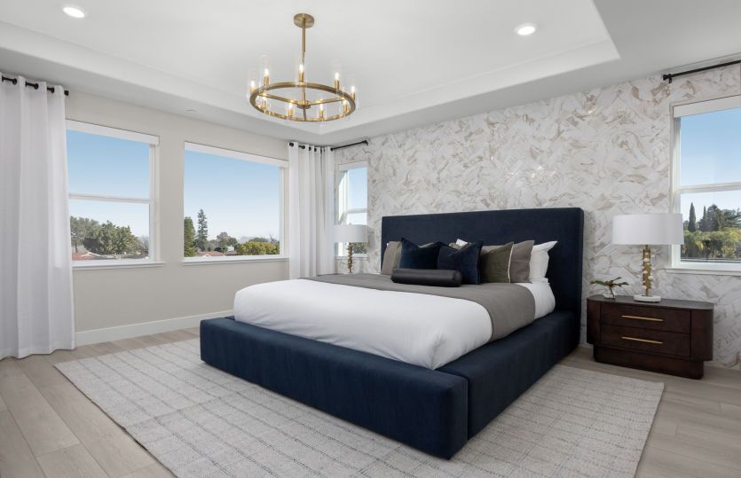 Bright primary bedroom suite with coffered ceiling