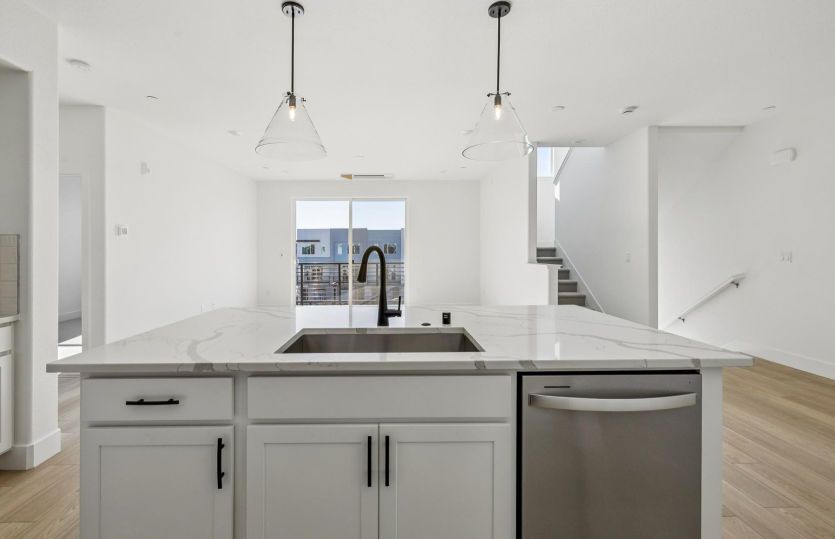 Kitchen overlooking gathering room and deck