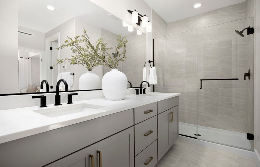 Owner's bathroom with dual vanity and glass walk-in shower