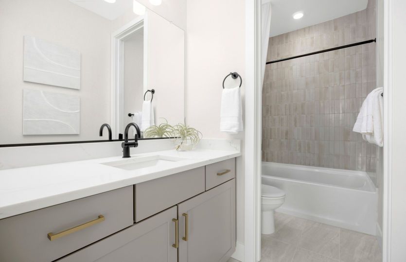 Bath 2 with tile surround and a tub shower