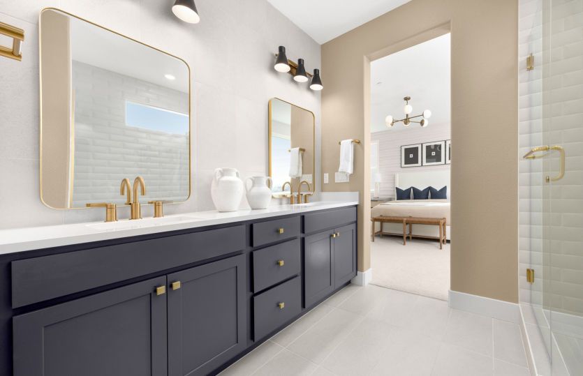 Primary bathroom with dual vanity and framed mirrors