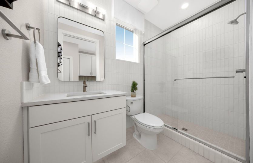 Bath 4 with glass walk-in shower in guest suite