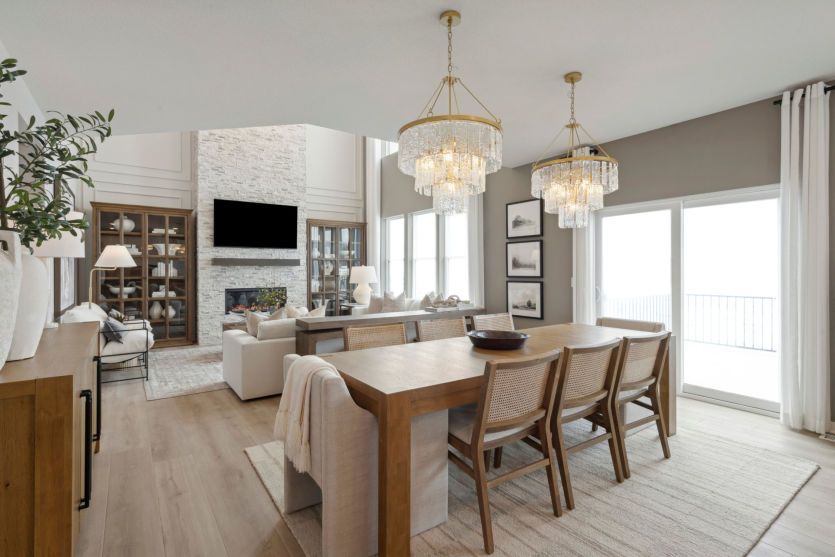 Spacious dining room with a formal table setting, large windows, and warm accents.