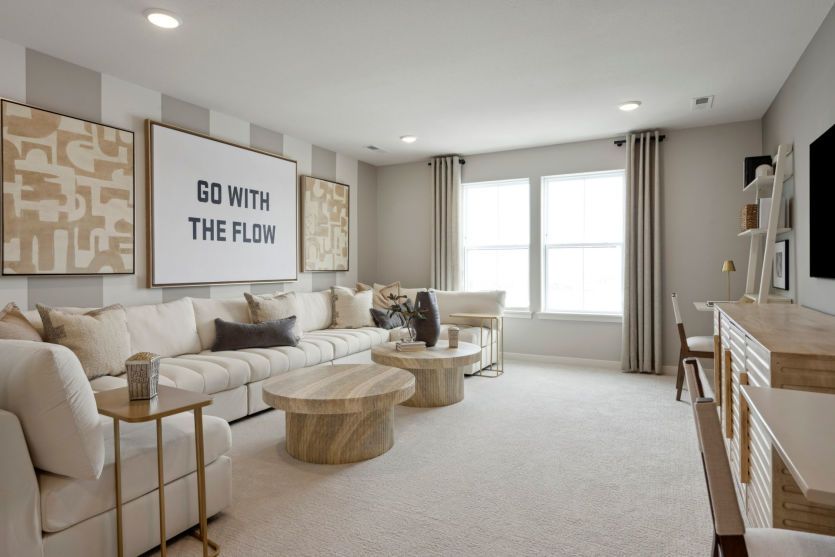 Expansive loft space with a work desk, entertainment area, and stylish furnishings.