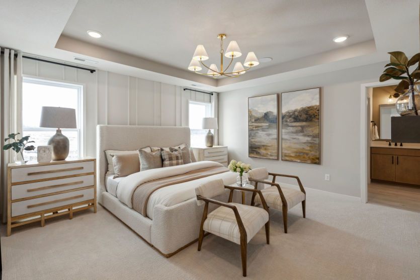 Bright and airy Primary Suite with a large bed, stylish finishes, and a private ensuite bathroom.