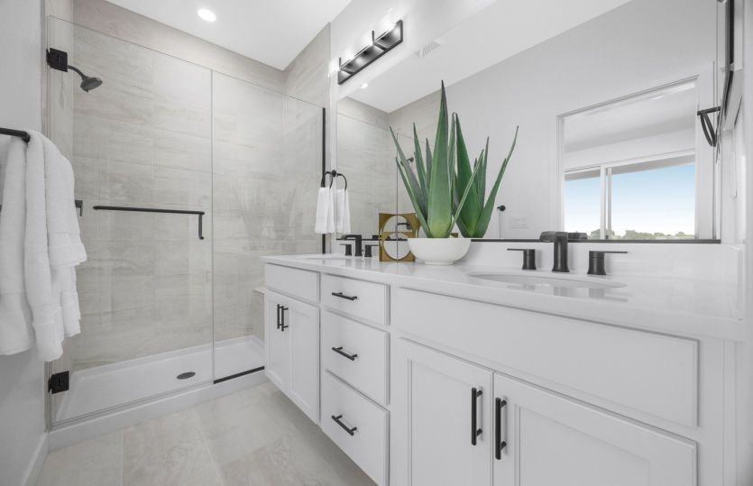 Primary bathroom with dual vanity and glass walk-in shower