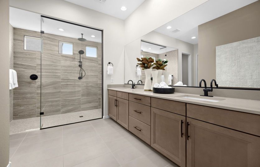 Luxurious Owner's Bath in the Ravenna home design complete with a tile shower and dual sinks.