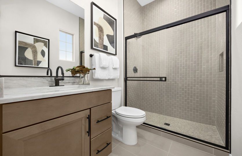 Bathroom serving the guest suite complete with a tile shower.