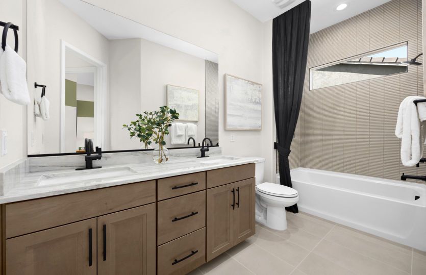 Secondary bathroom serving the bedrooms offers a tub and shower combo and an optional second sink.