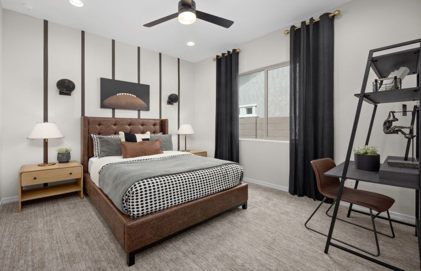 Secondary bedroom 2 with decorative paint details and an overhead ceiling fan.