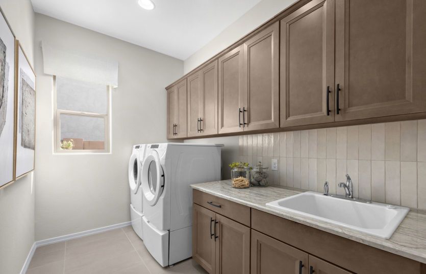 Ravenna laundry room complete with extra cabinets, an optional sink, and a bright window.