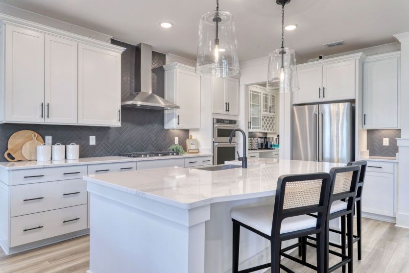Spacious open-concept kitchen with modern finishes and ample counter space.