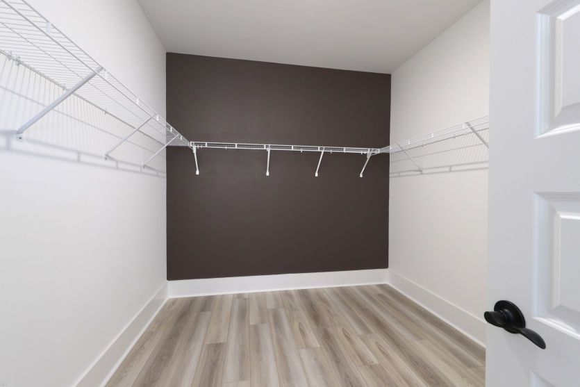 Large walk-in owner’s closet with customizable storage solutions.