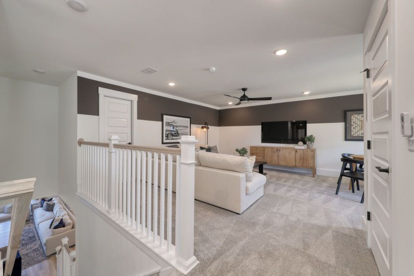 Versatile upstairs loft perfect for a media room or play area.