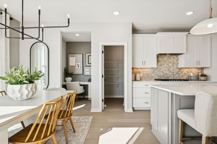 Standing in the dining room, looking into the kitchen and the Pulte Planning Center beyond