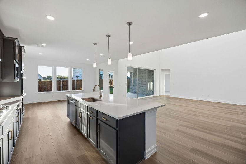 Large kitchen island overlooking main living areas *photos may depict options and features that aren