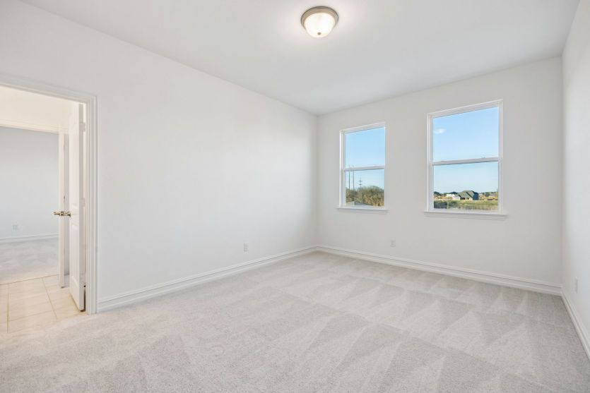 Secondary bedroom with large windows *photos may depict options and features that aren't available