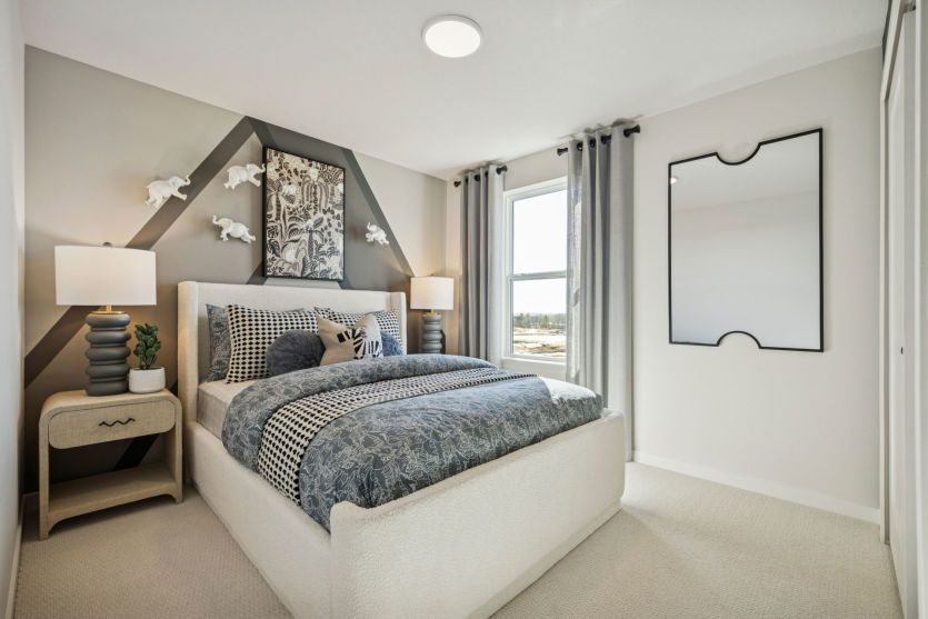 Comfortable secondary bedroom with warm decor and plenty of natural light.