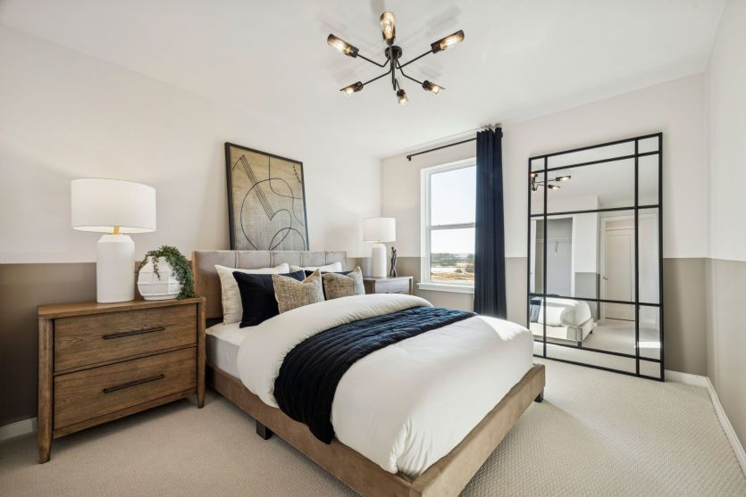 Comfortable secondary bedroom with warm decor and plenty of natural light.