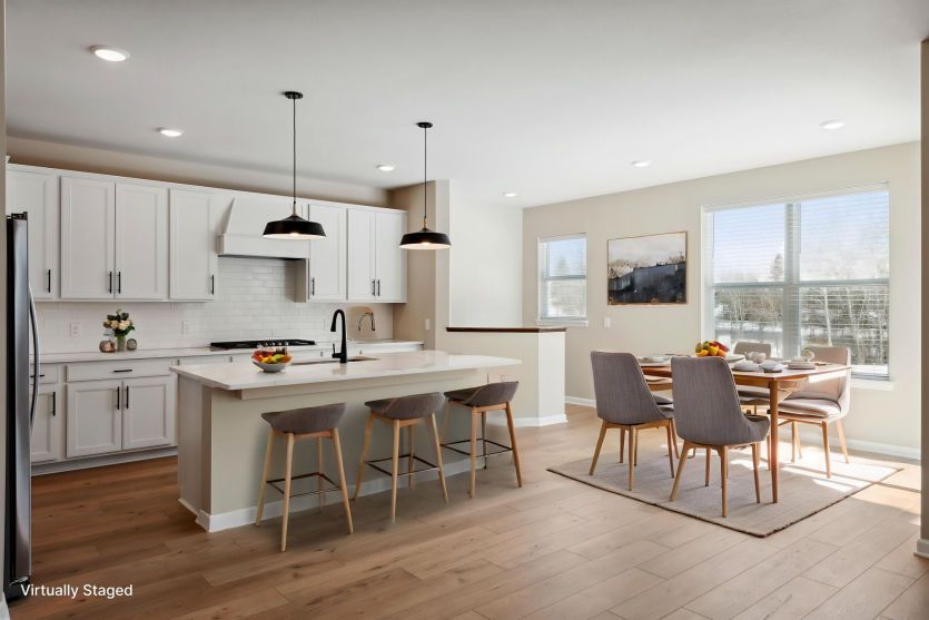 The kitchen flows seamlessly into the bright and sunny dining room.