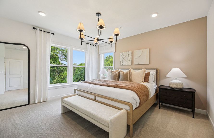 Sunlit Owner's Suite with a Walk-In Closet and Luxurious Bath