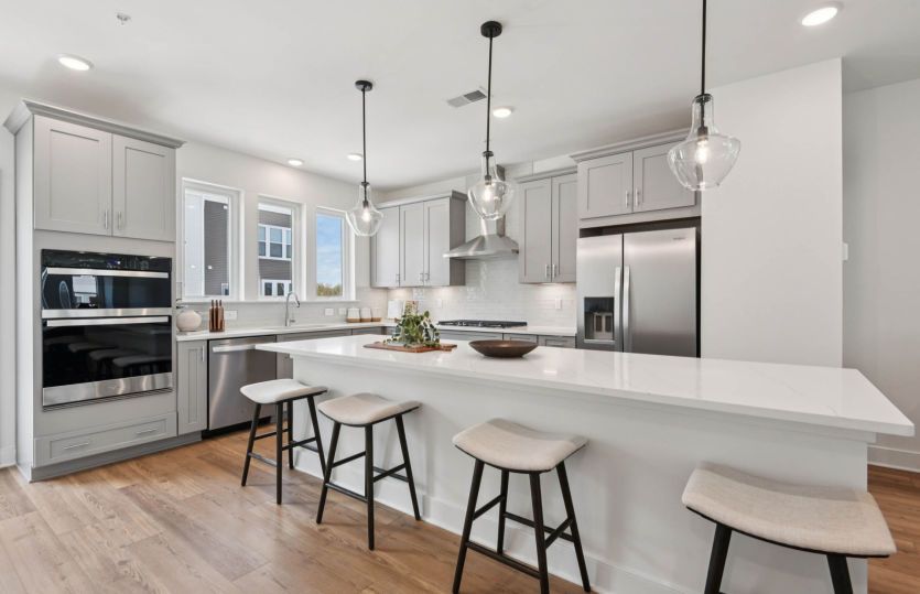 Gourmet Kitchen with Expansive Island and Stainless Steel Appliances - Actual Home