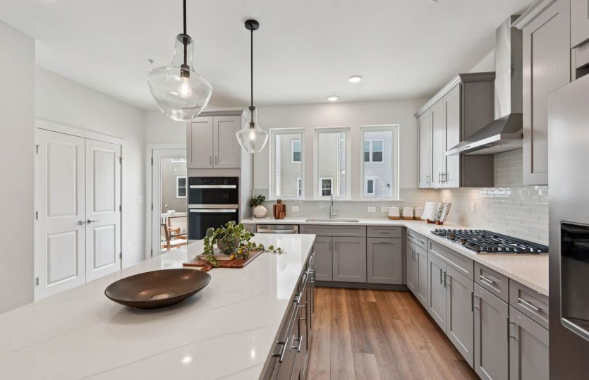 Stainless Steel Appliances and Quartz Countertops in the Gourmet Kitchen - Actual Home