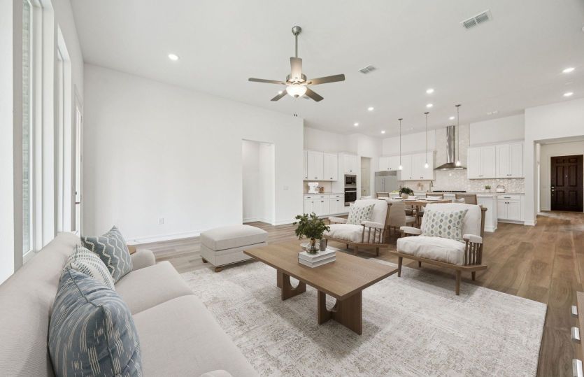 Bright open kitchen and family room with large island and connected seating space.