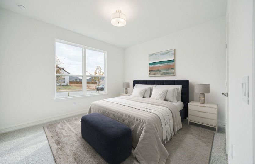 Comfortable guest bedroom with convenient access to nearby bathroom.