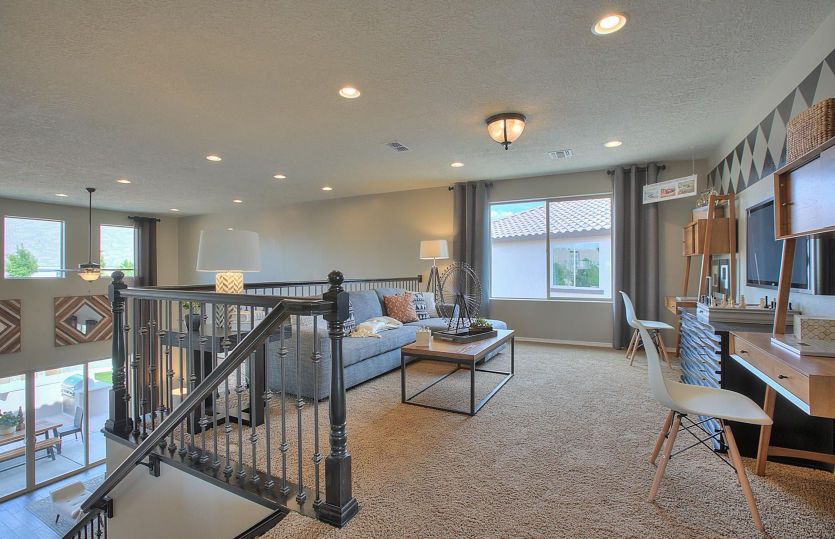 Upstairs you'll find a loft that creates a comfortable space to cozy up and watch movies or play boa