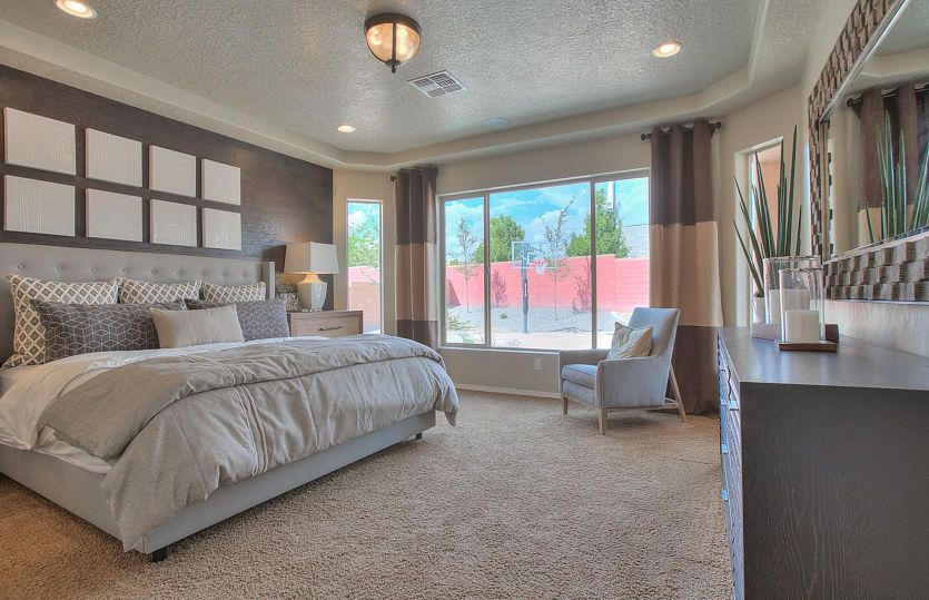 Owner's suite designed with carpet, tray ceiling and a bay window that provides a cozy nook for read