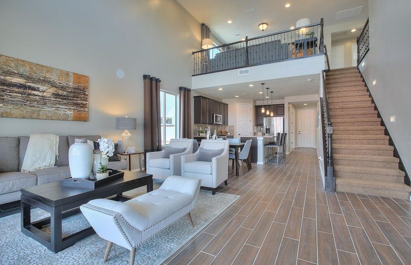 Wrought-iron stair railings bring an even brighter feel to the gathering room and loft of the Firwoo