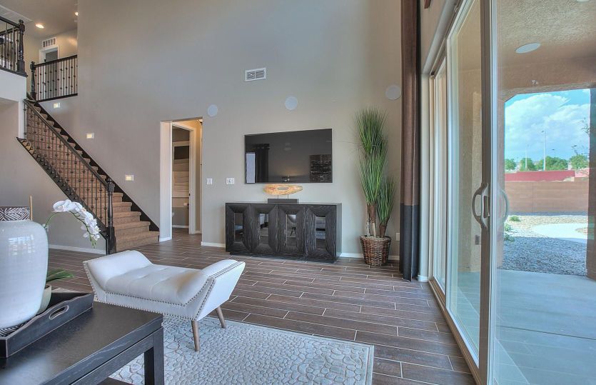 Center sliding glass door leads to a large covered patio and backyard for indoor to outdoor family t