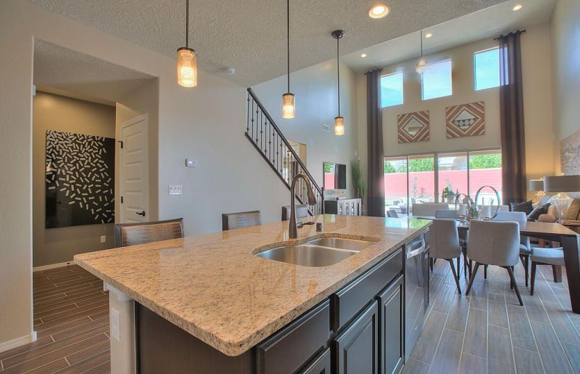 Add pendant lighting over the kitchen island and match it with a coordinating granite color for an i