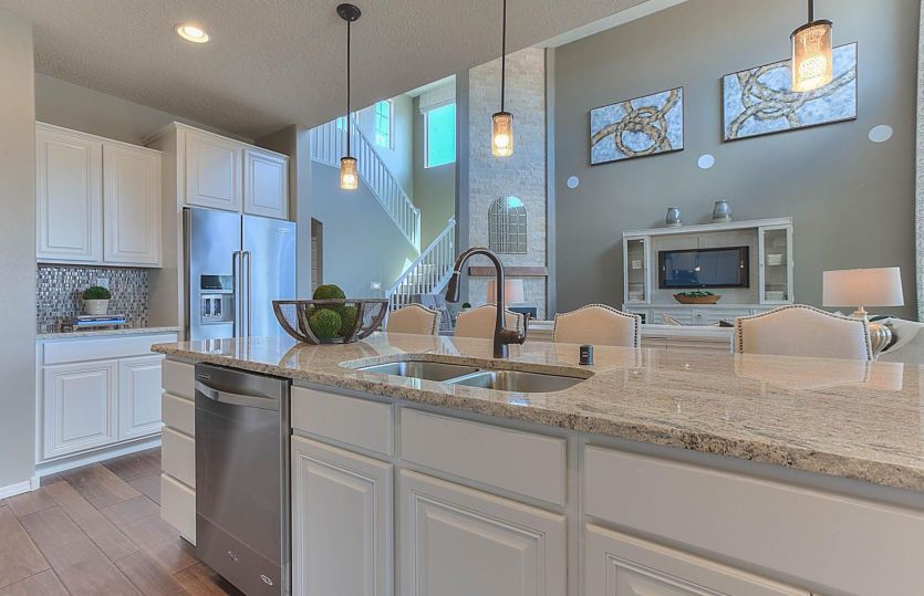 Kitchen island featuring granite countertops and optional pendant lighting.
