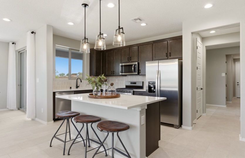 Stainless steel Kitchenaid® appliances including a gas cooktop, vent hood, built-in oven and dishwas