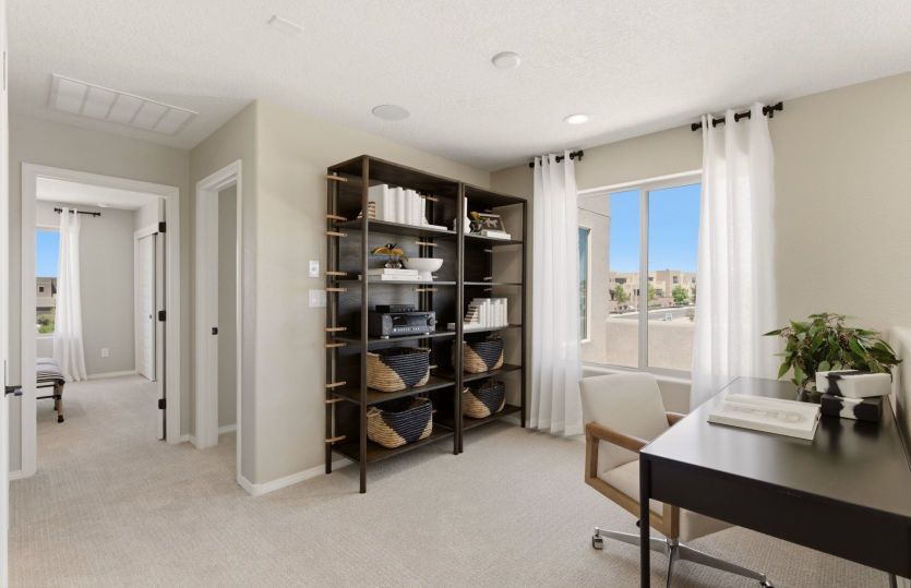 The loft upstairs makes another flexible living area on this home design for a home office, home gym