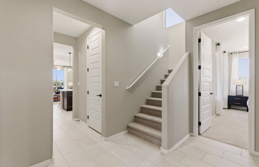 Entry off the two-car garage leads to first floor owner's suite, laundry and into kitchen.