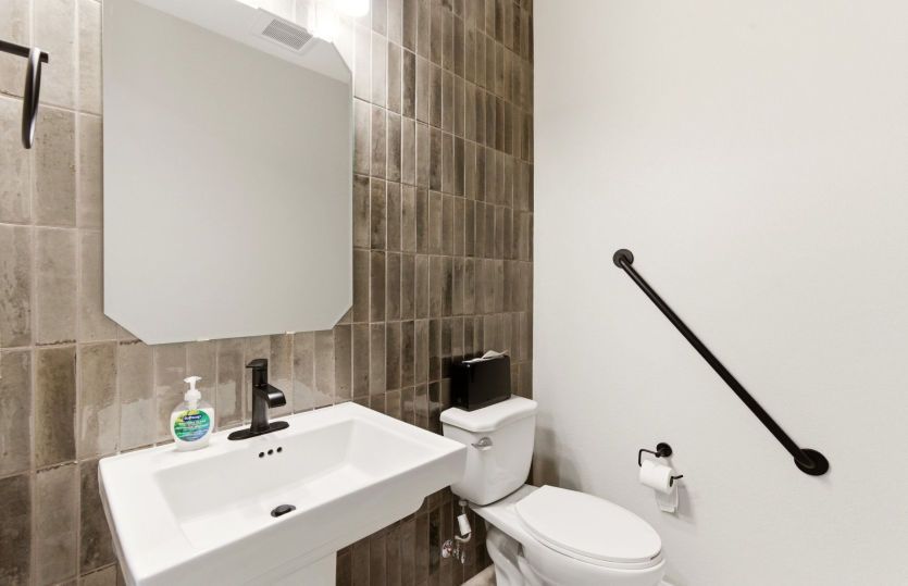 First floor powder bath serves visiting guests and is easily accessible from the kitchen and gatheri