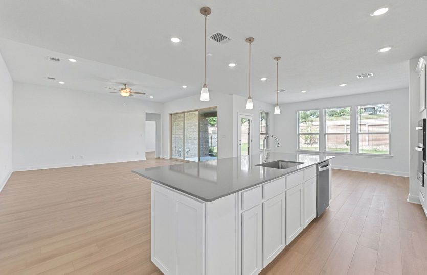 Representational Photo- Kitchen Open to the Gathering Space and Dining Area