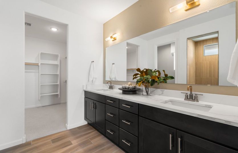 Dual vanity boasts a large mirror and ample cabinet space.