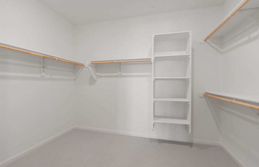 The walk-in closet provides ample storage.