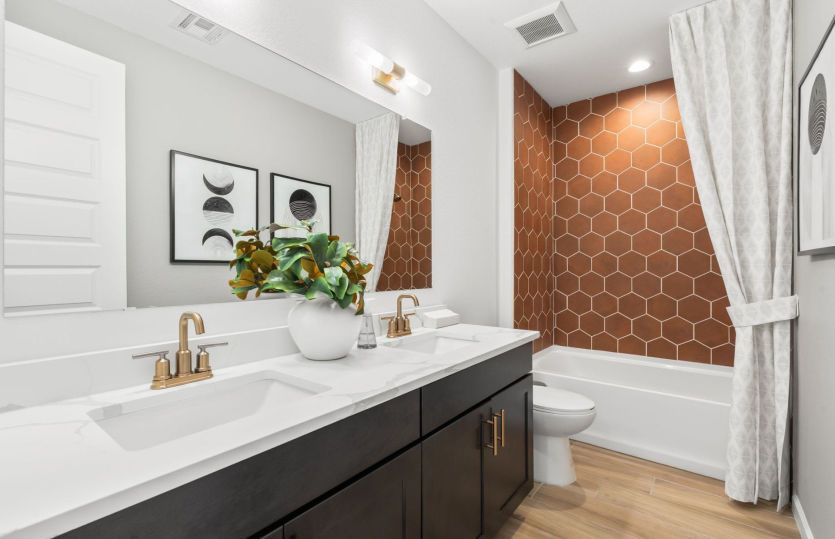 Secondary bath shown here with a large vanity and walk-in shower.