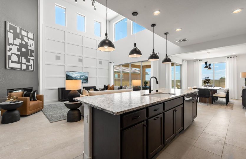 The kitchen island contains a large sink and dishwasher plus additional cabinets.