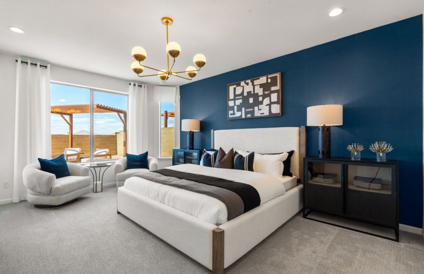 The owner's suite is finished with an accent wall and decorative light fixture.