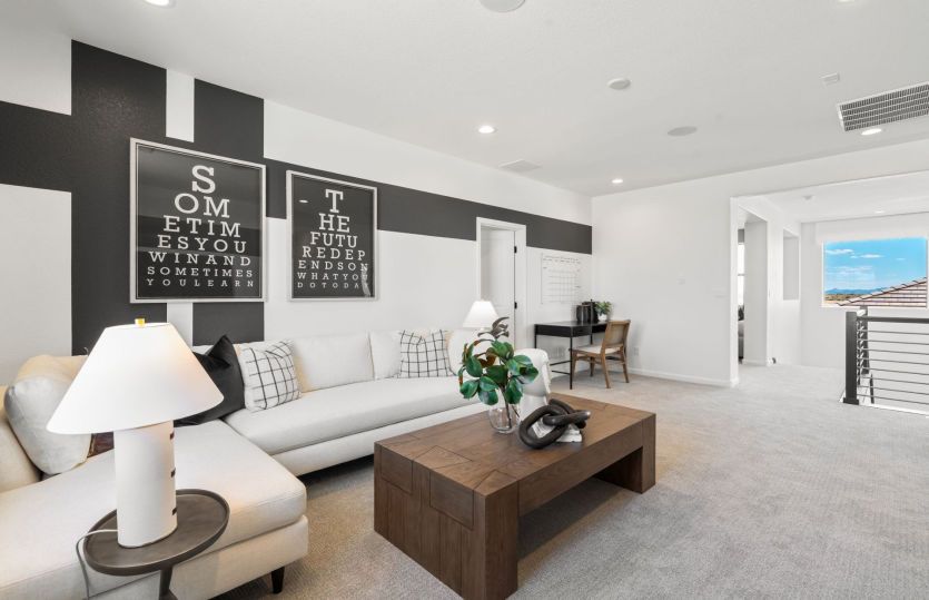 Off the stairs on the second floor is a spacious loft living area serving as a flexible play room be